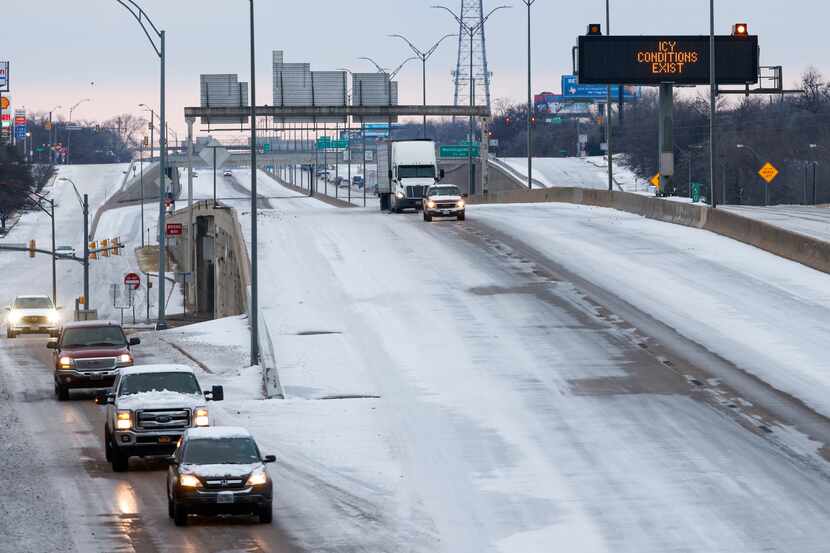 Motorists travel along a snow and ice covered I-35W on Friday, Feb. 4, 2022 in Fort Worth....