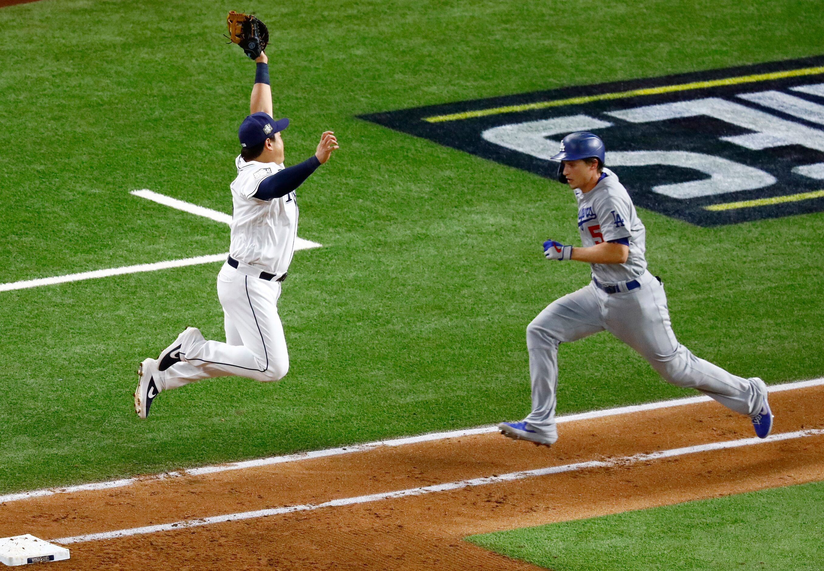 Tampa Bay Rays first baseman Ji-Man Choi (26) leaps to catch a throw and tag out Los Angeles...