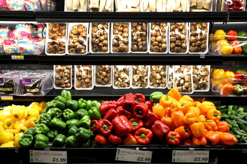 Peppers and mushrooms are on display in the produce section inside H Mart in Carrollton, Texas.