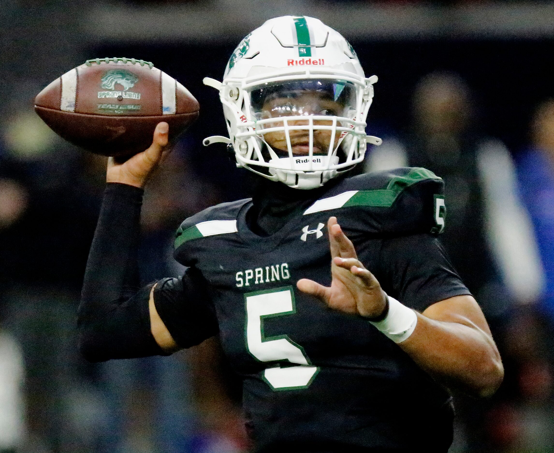 Spring High School quarterback Bishop Davenport (5) throws a pass during the first half as...