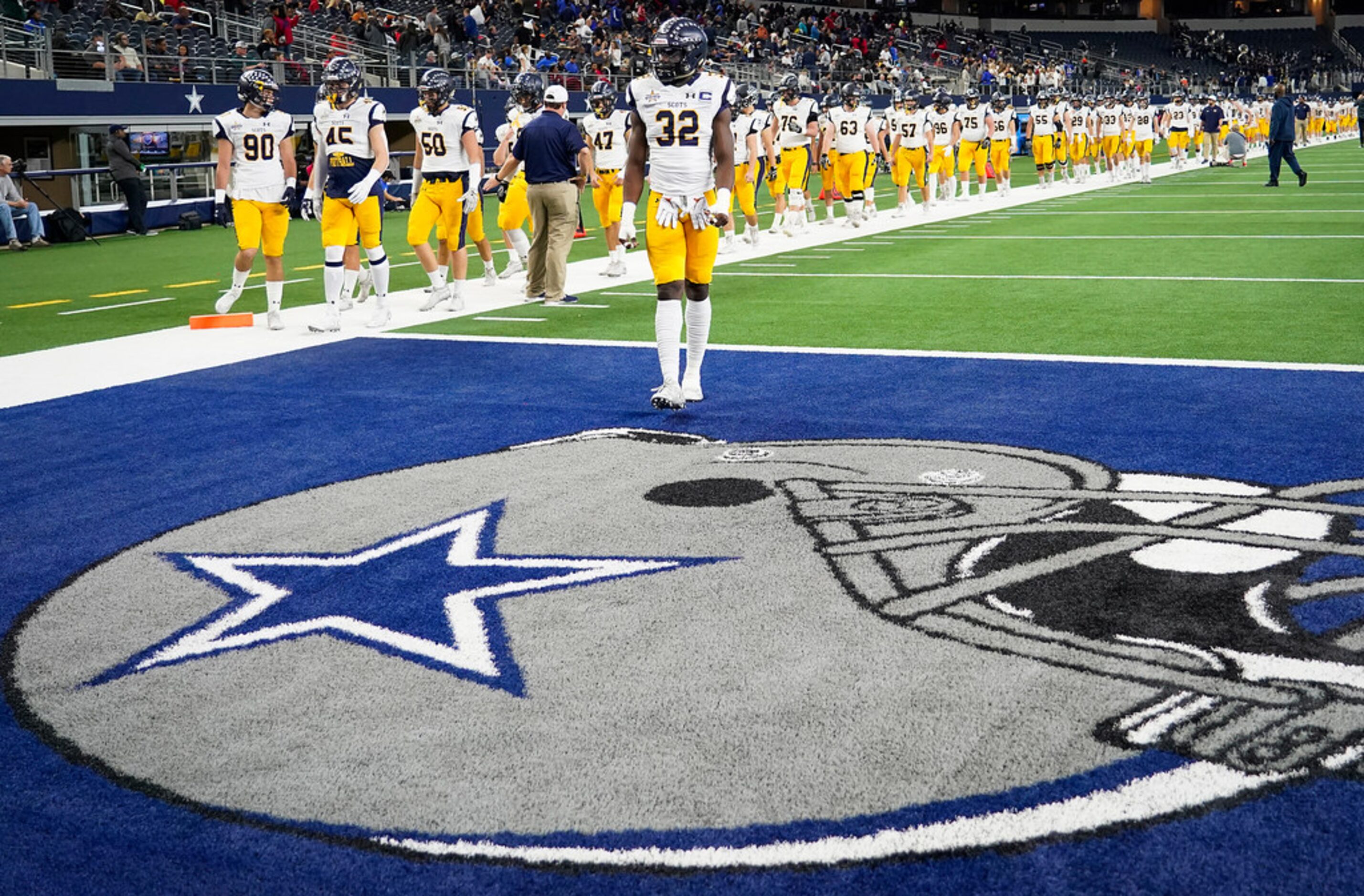 Highland Park players take the field to warm up before in a Class 5A Division I Region II...