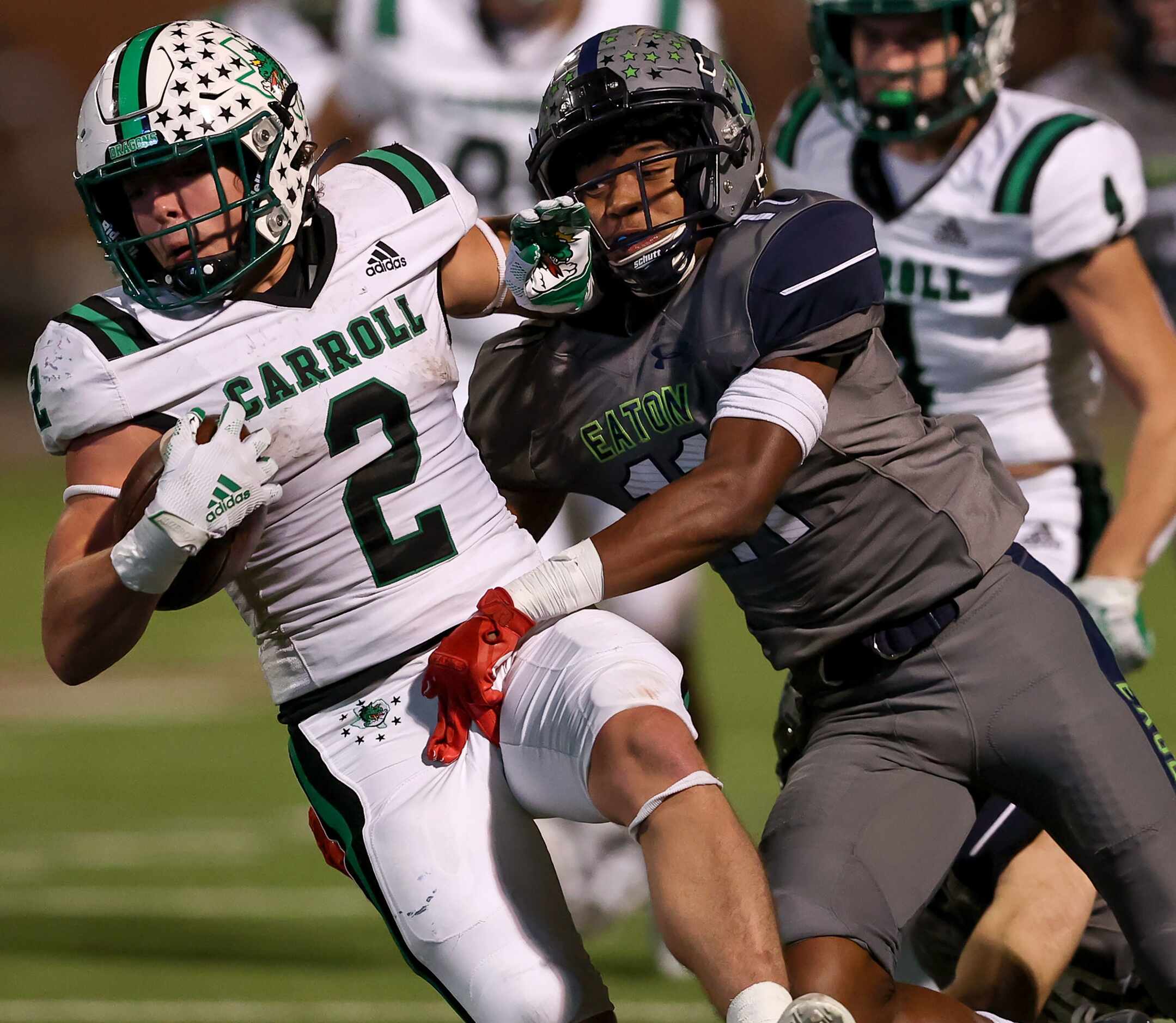 Southlake Carroll running back Owen Allen (2) gets brought down by Eaton cornerback Chase...