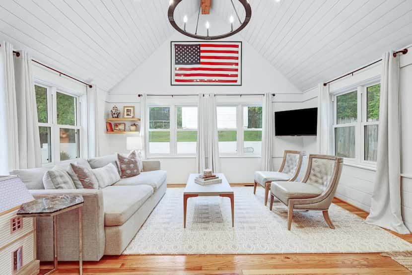 A family room with a vaulted ceiling and shiplap details has classic charm. The current...
