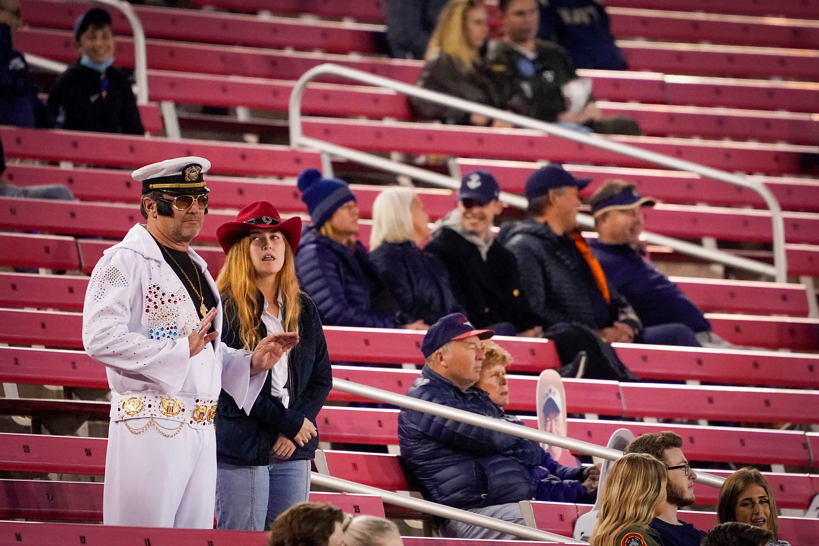 Costumed SMU fans cheer their team during  during the third quarter of a Halloween night...