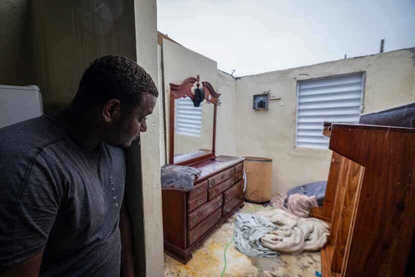 Nelson Cirino sees his bedroom after the winds of hurricane Fiona tore the roof off his...