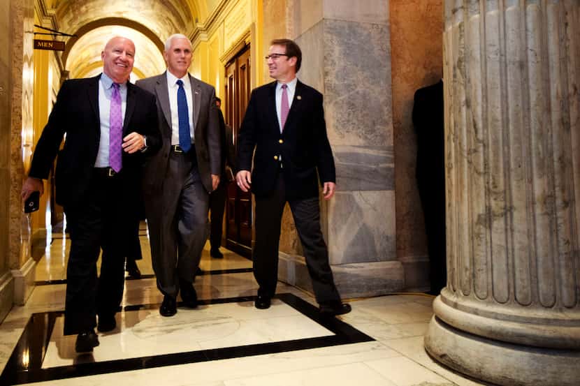 Vice President Mike Pence walks with Rep. Kevin Brady, R-Texas, left, and Rep. Peter Roskam,...