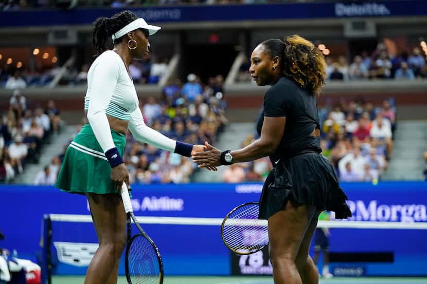 Serena Williams, right, and Venus Williams, of the United States, celebrate during their...
