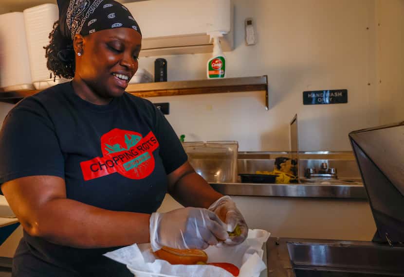 Keke Samba puts dressing and toppings on an order from her vegan Afro-Caribbean food truck,...