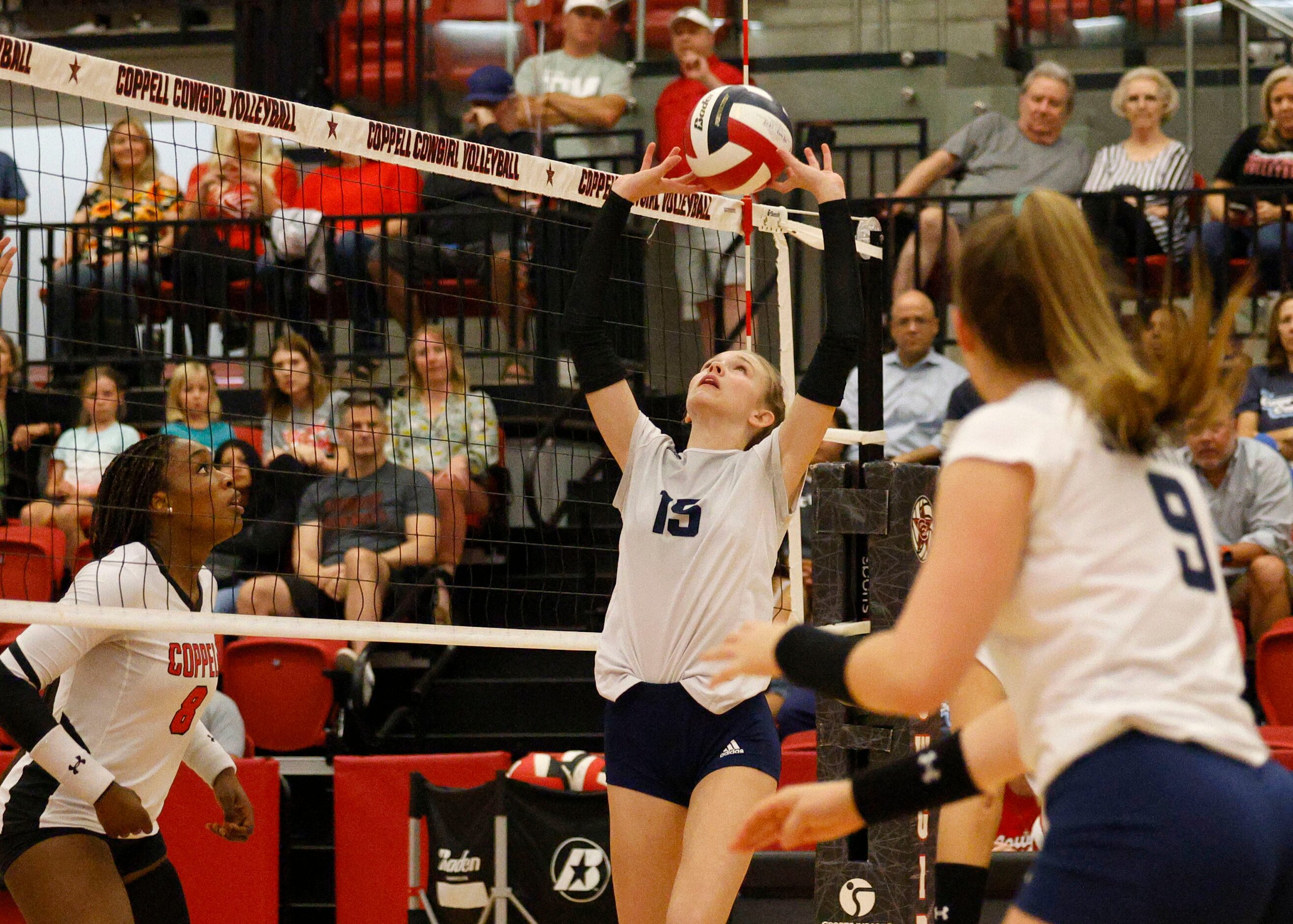 Flower Mound's Hayden Curtis (15) sets the ball as Coppell's Daki Kahungu (8) and Flower...