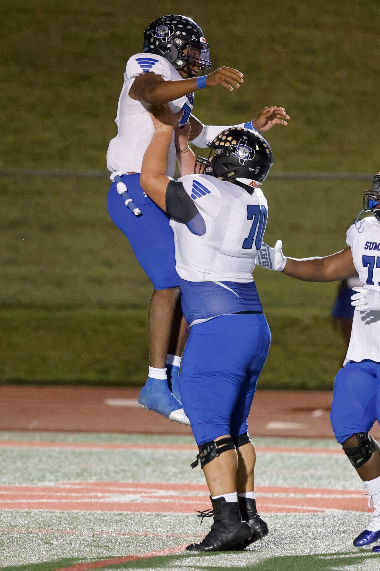 Mansfield Summit quarterback David Hopkins celebrates his touchdown run with Carlos...