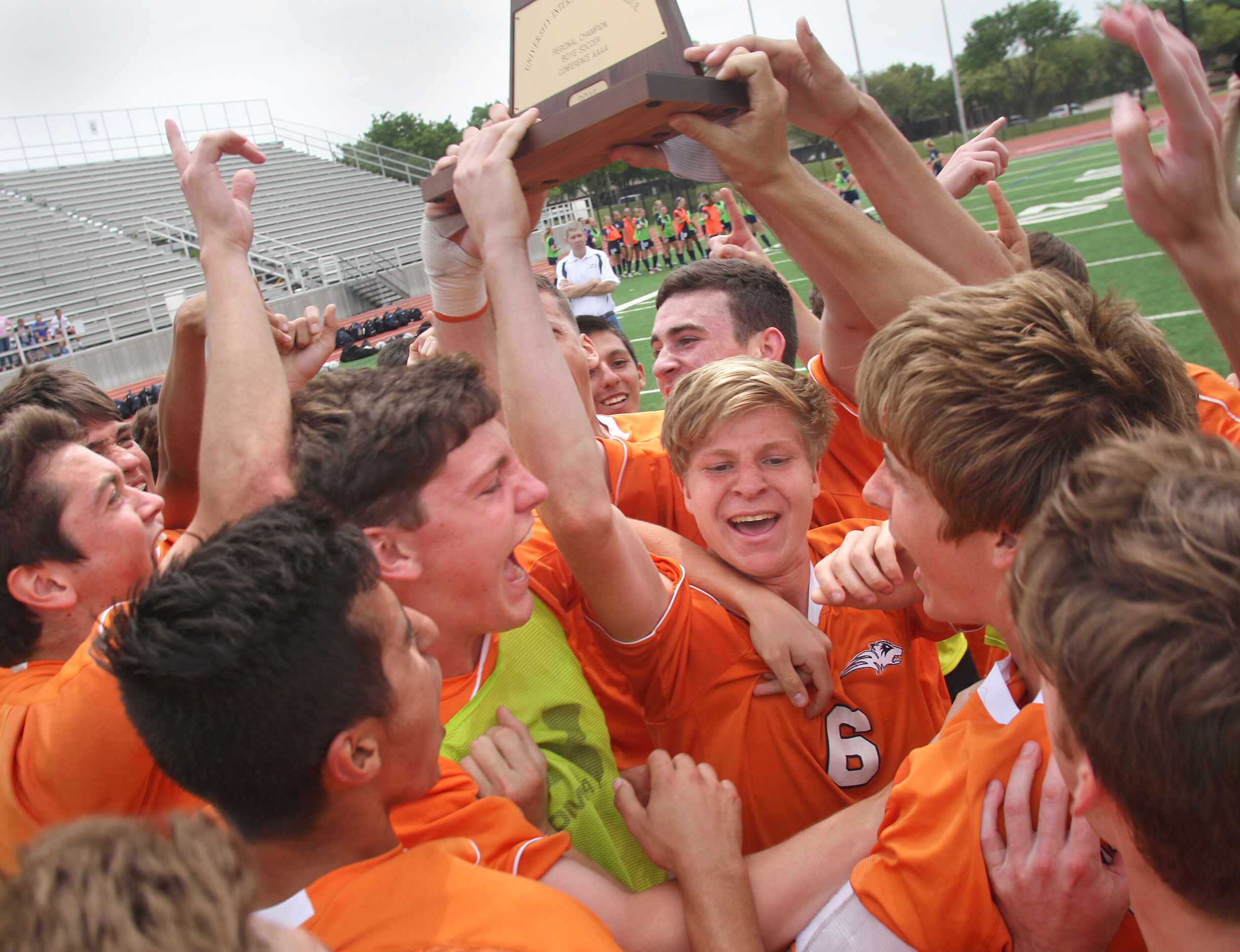 The Frisco Wakeland soccer team hold up their trophy in celebration after defeating Frisco...