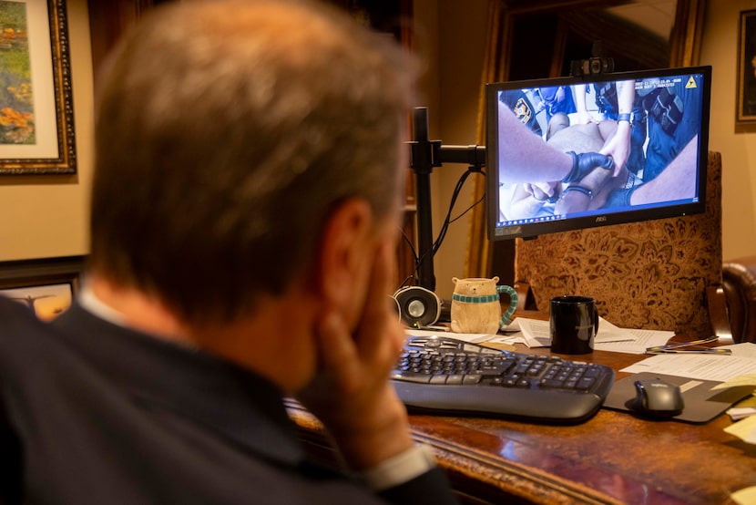 Geoff Henley, the attorney for the family of Kenneth Knotts, watches body-worn camera...