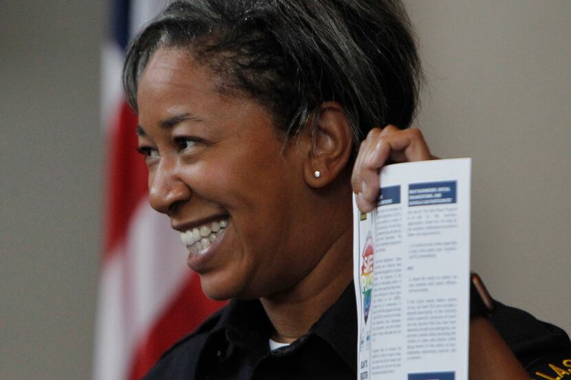 Dallas Police Department's new LGBTQ+ liaison, officer Megan Thomas, shares printed...