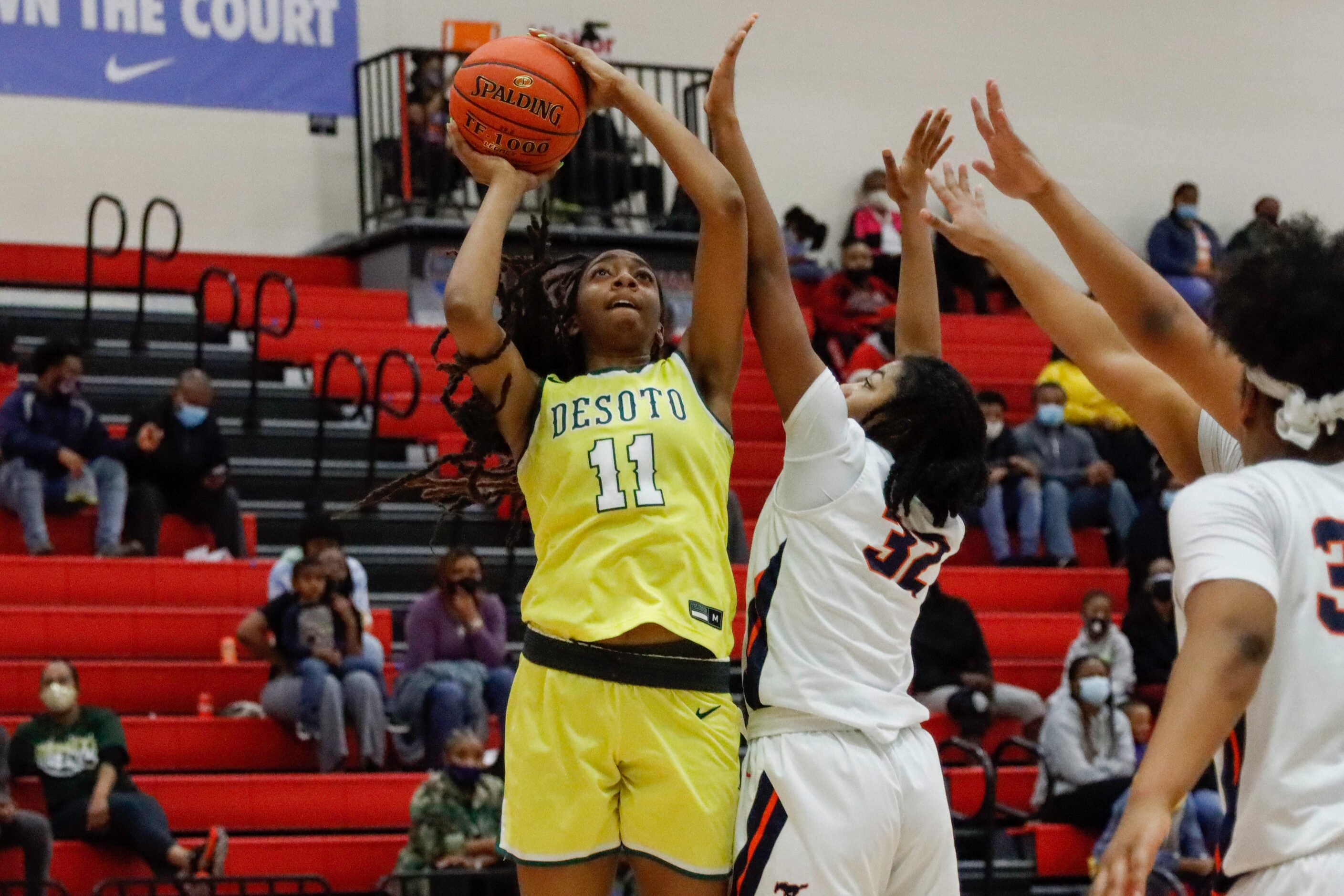 DeSoto’s Tionna Herron (11) shoots the ball over Sachse’s Micah Cooper (32) during the...