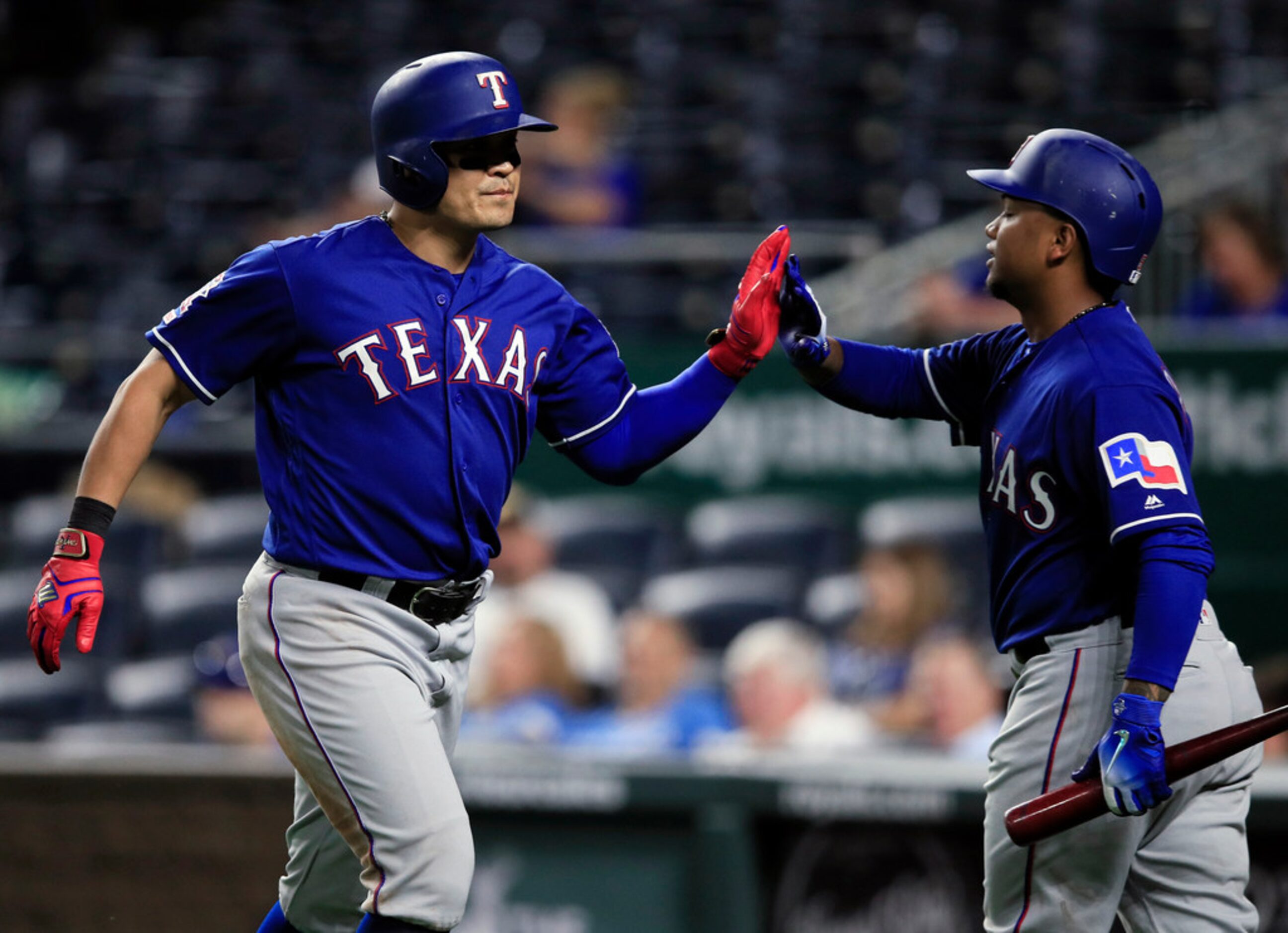 Texas Rangers' Shin-Soo Choo, left, is congratulated by Willie Calhoun after his solo home...