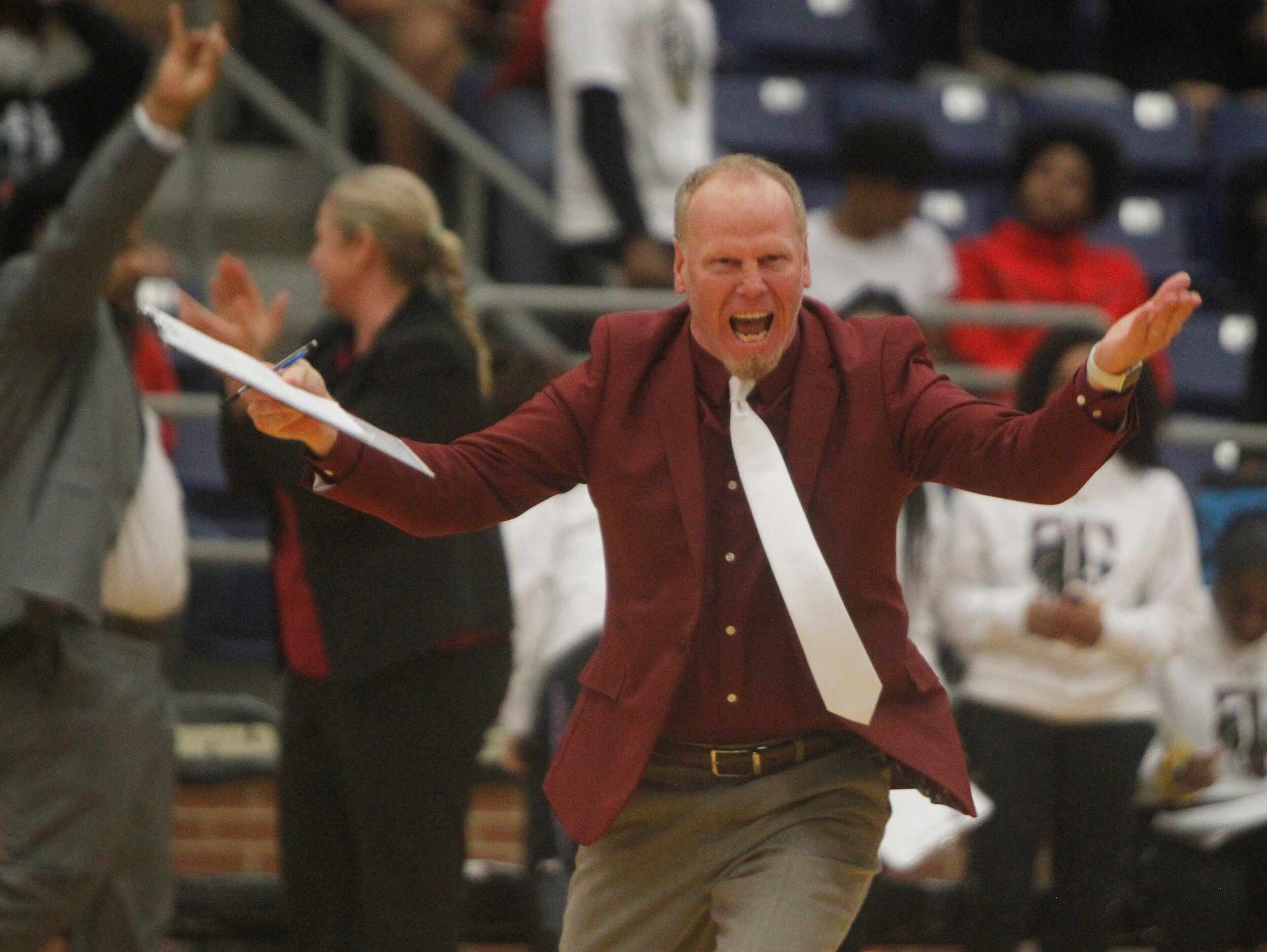Mansfield Timberview assistant coach Gabe Hicks celebrates following Timberview's 48-44...