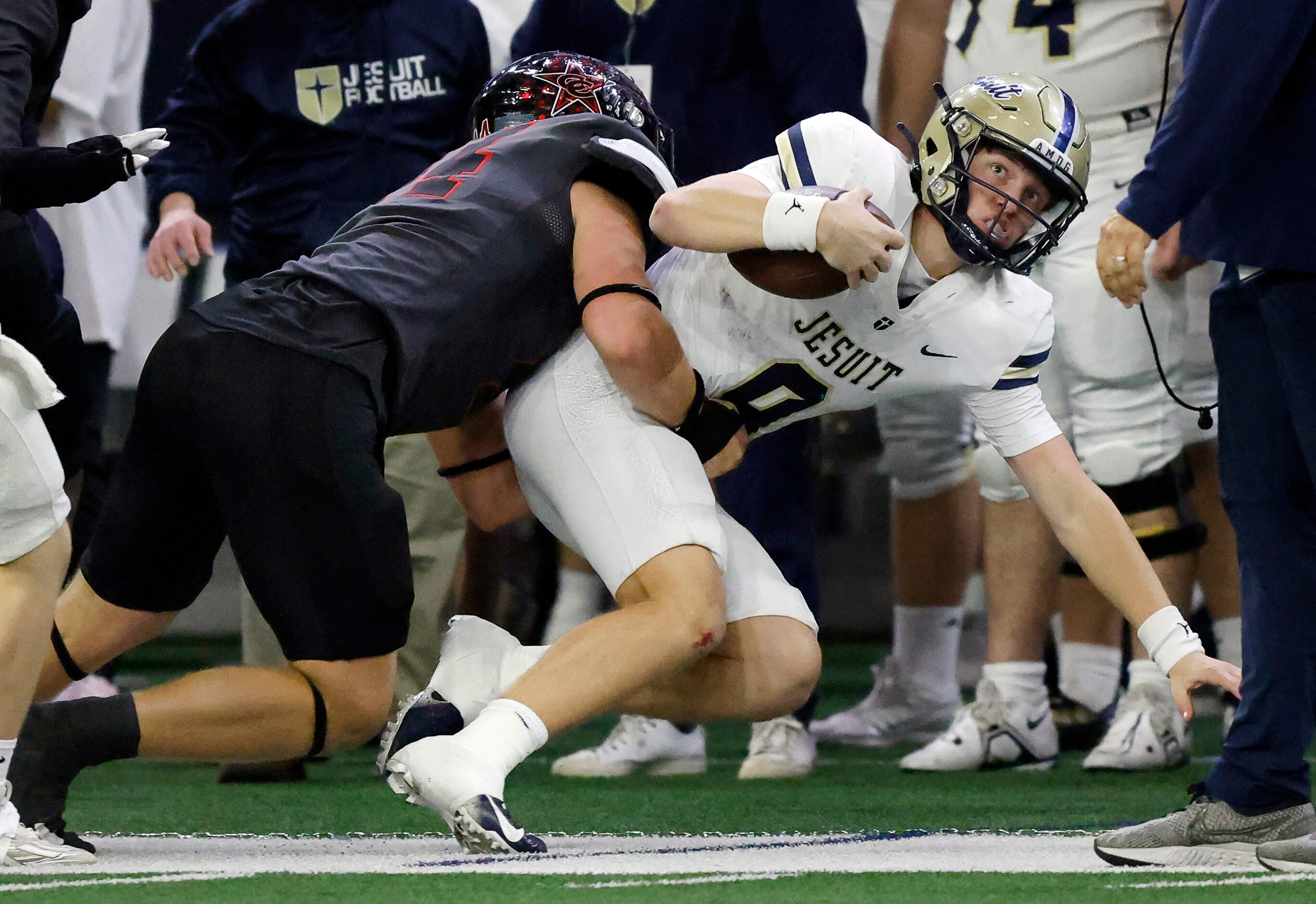 Coppell defensive lineman Blake Isbell (44) drives Jesuit quarterback Charlie Peters (9) out...