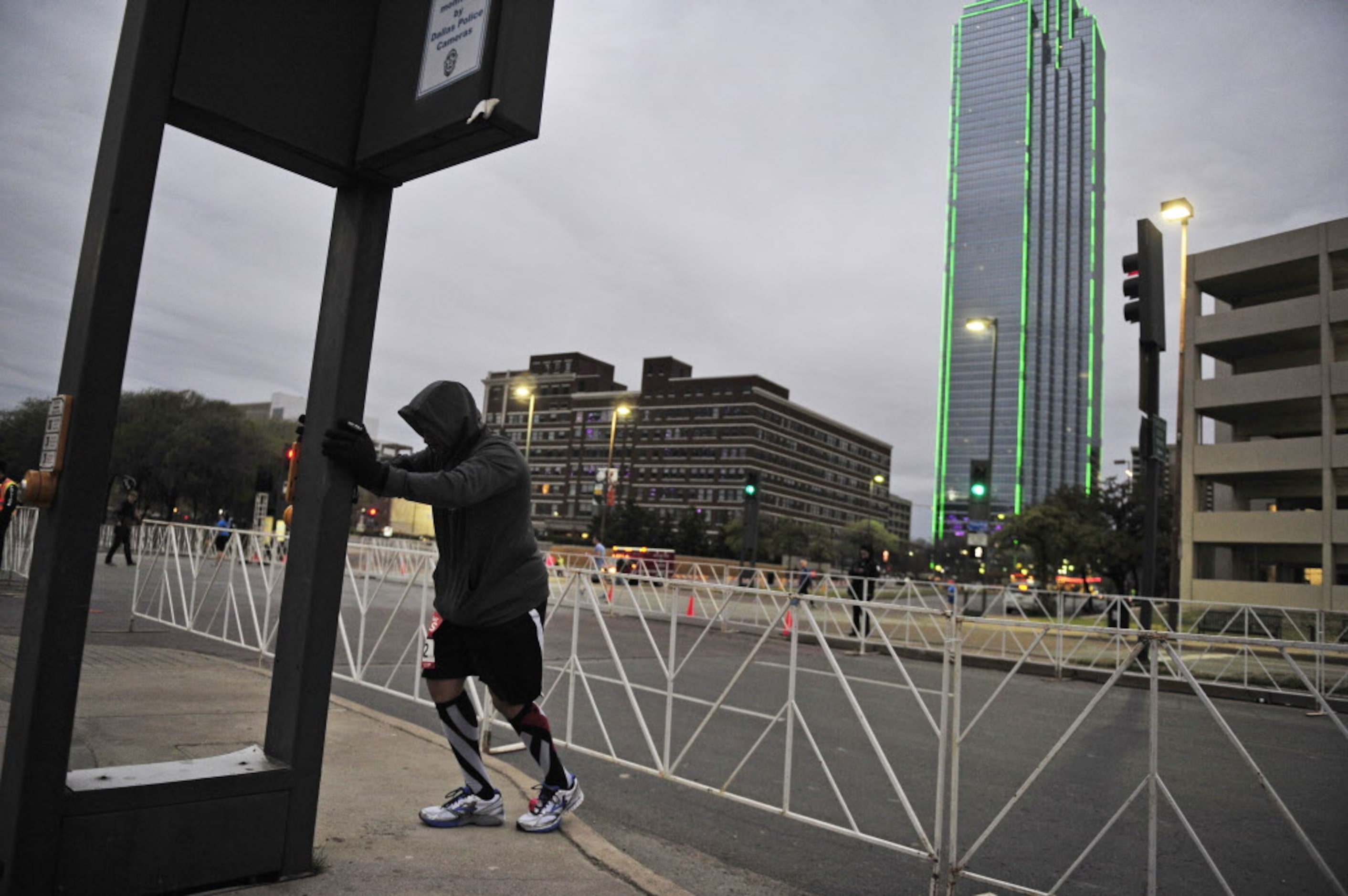 Chris Coleman stretches before the start of the Dallas Rock N' Roll half-marathon on Sunday,...