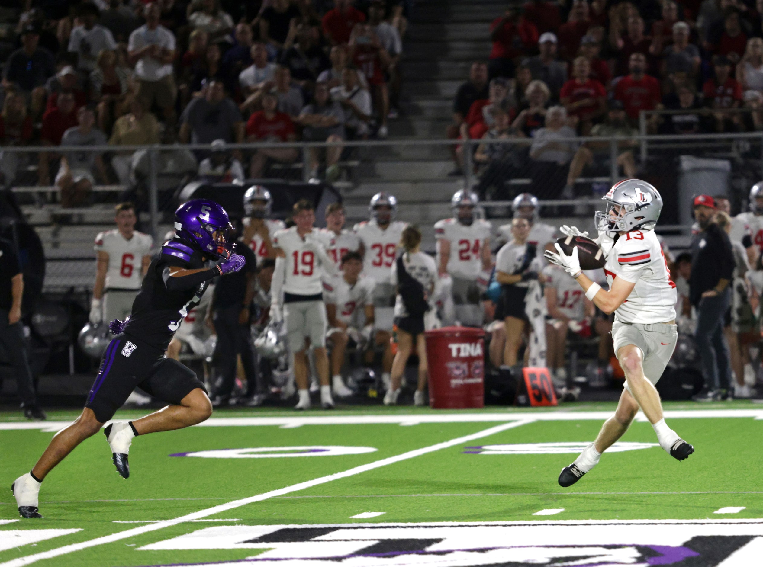 Lovejoy player #13 Zane Kuzenski catches a pass and runs for a touchdown during the Lovejoy...