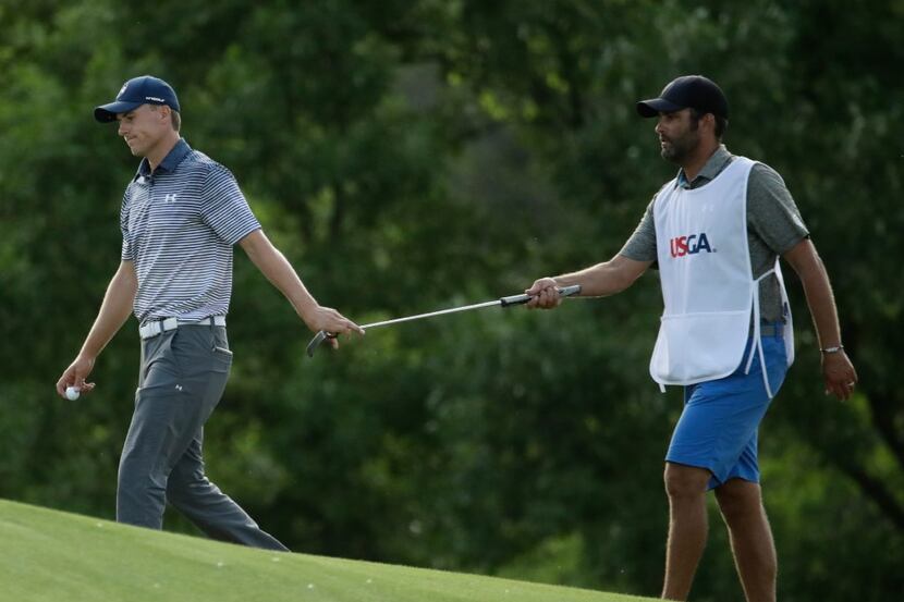Jordan Spieth is handed a putter on the 15th hole during the second round of the U.S. Open...