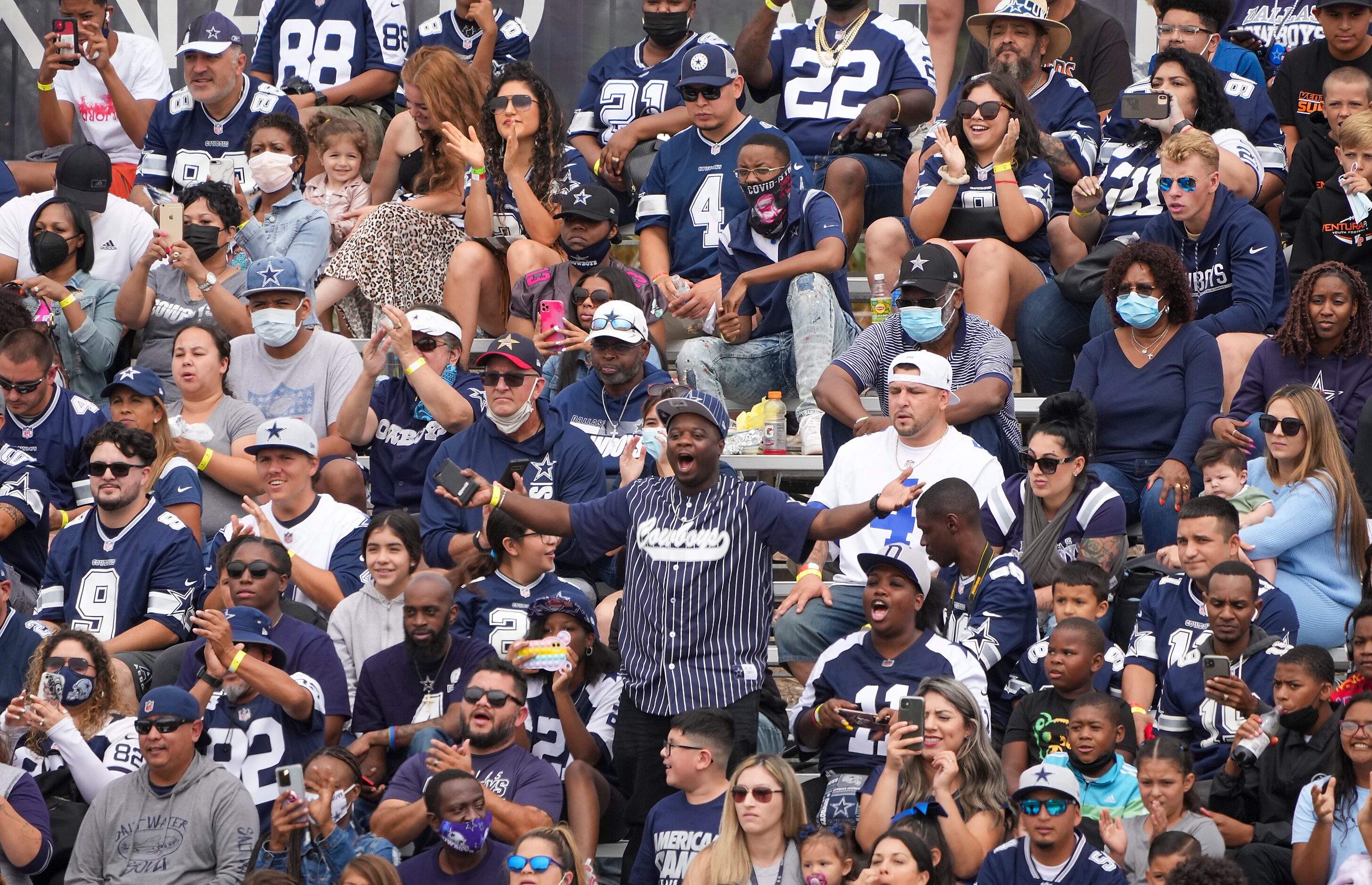 Dallas Cowboys fans cheer their team during a practice at training camp on Saturday, July...