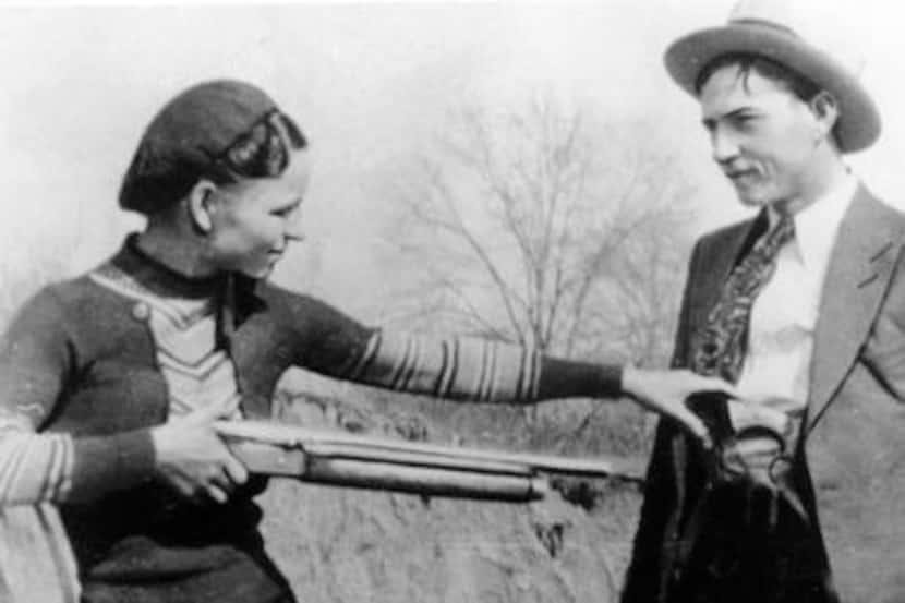 
Bonnie Parker playfully pointed a rifle at Clyde Barrow in a photo taken during their...