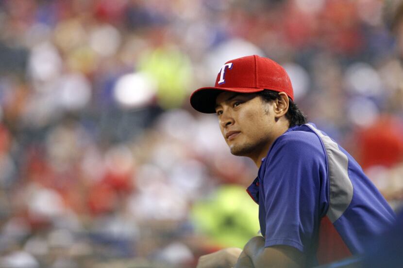 Texas Rangers starting pitcher Yu Darvish (11) watches the ninth inning from the dugout rail...