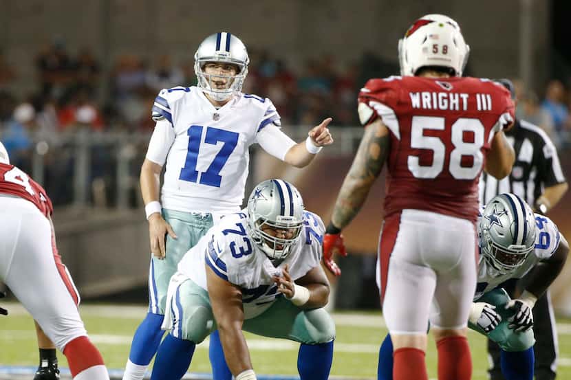 Dallas Cowboys quarterback Kellen Moore (17) communicates to his teammates before the snap...