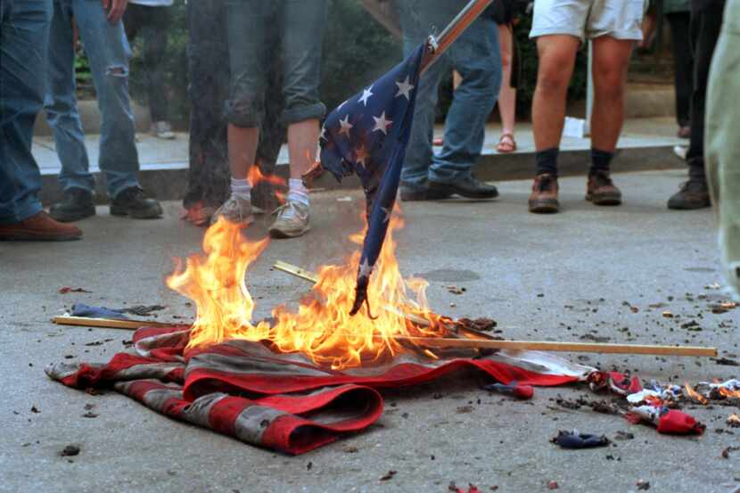 This 20 April 2002 file photo shows demonstrators burning US flags in front of the World...