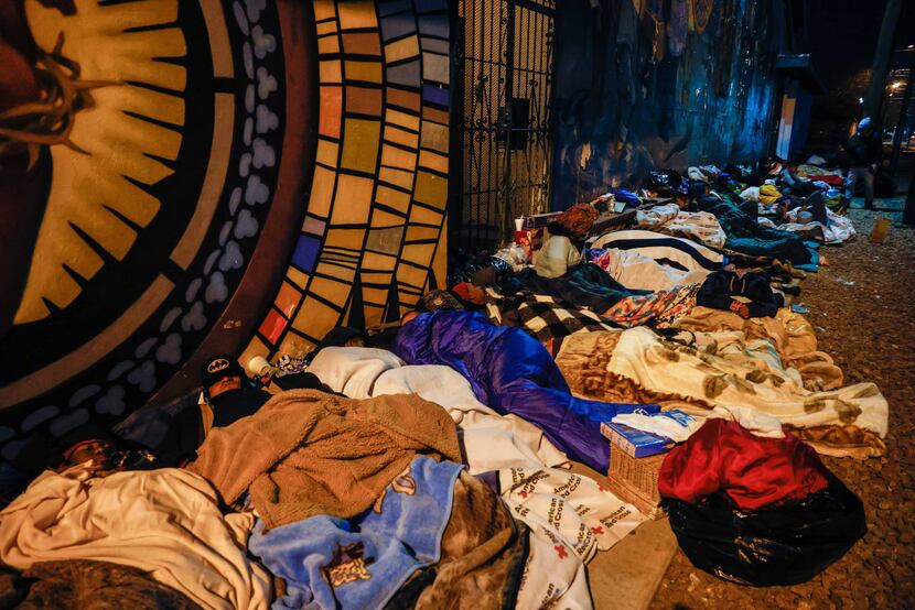 Migrants spent the night on the street at the Centro Pastoral Sagrado Corazon in El Paso on...
