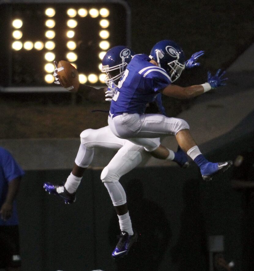 Grand Prairie receiver Peyton Westmoreland (7), left, celebrates with teammate Matt Lechuga...