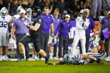 TCU quarterback Max Duggan (15) races past Kansas State linebacker Nick Allen (52) during...