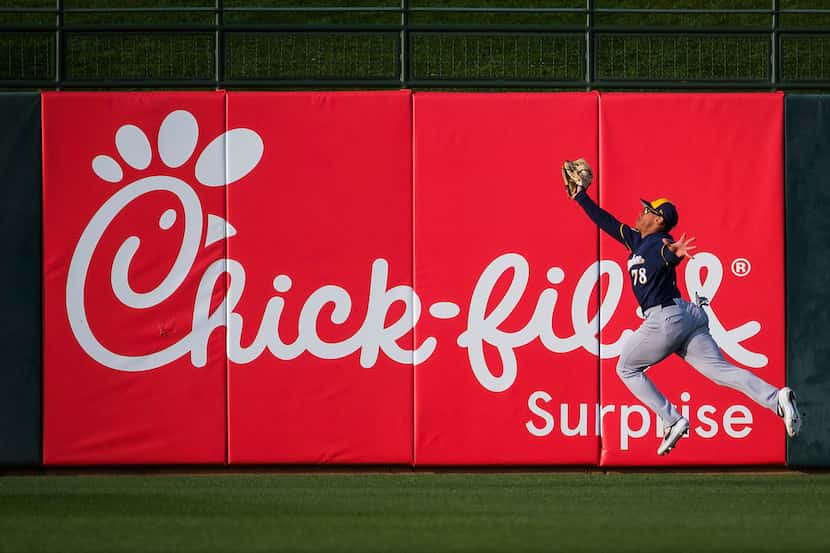 Milwaukee Brewers center fielder Corey Ray makes a leaping catch on a ball off the bat of...