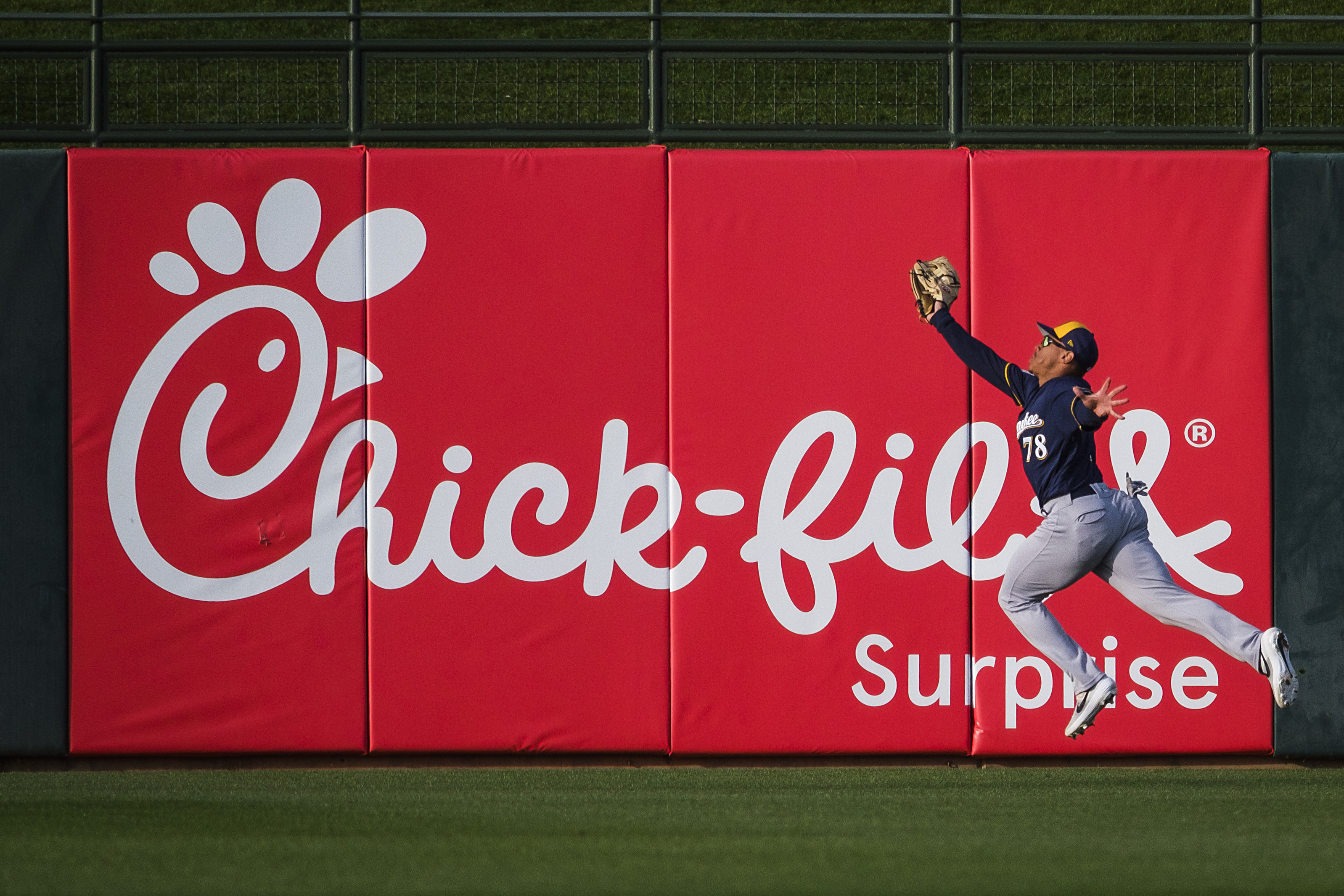 Milwaukee Brewers center fielder Corey Ray makes a leaping catch on a ball off the bat of...