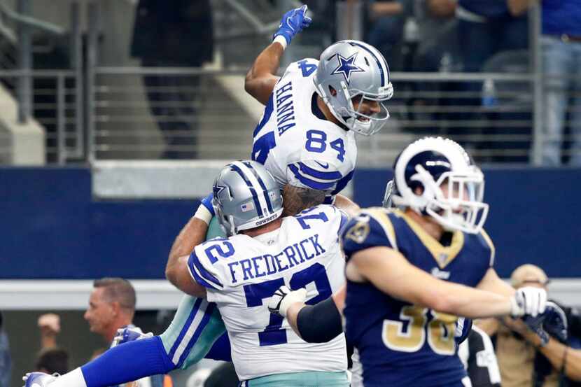 Dallas Cowboys tight end James Hanna (84) is hoisted in the air by teammate Travis Frederick...