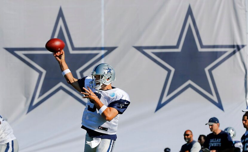 Dallas Cowboys quarterback Tony Romo (9) throws a pass during afternoon practice at training...