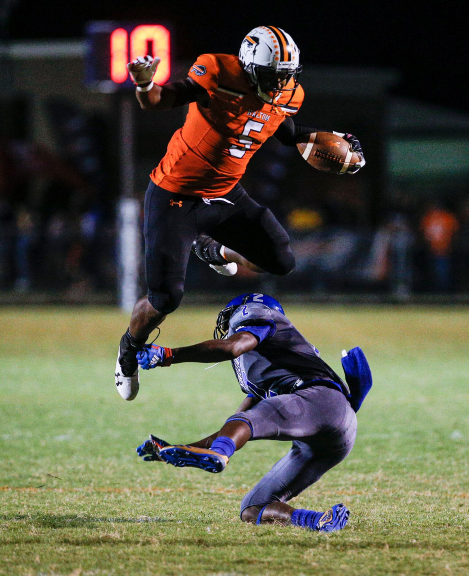 TXHSFB Haltom City senior running back Kenneth Cormier Jr. (5) jumps over North Mesquite...