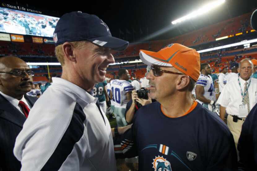 Dallas head coach Jason Garrett (left) and Miami head coach Tony Sparano meet at midfield...