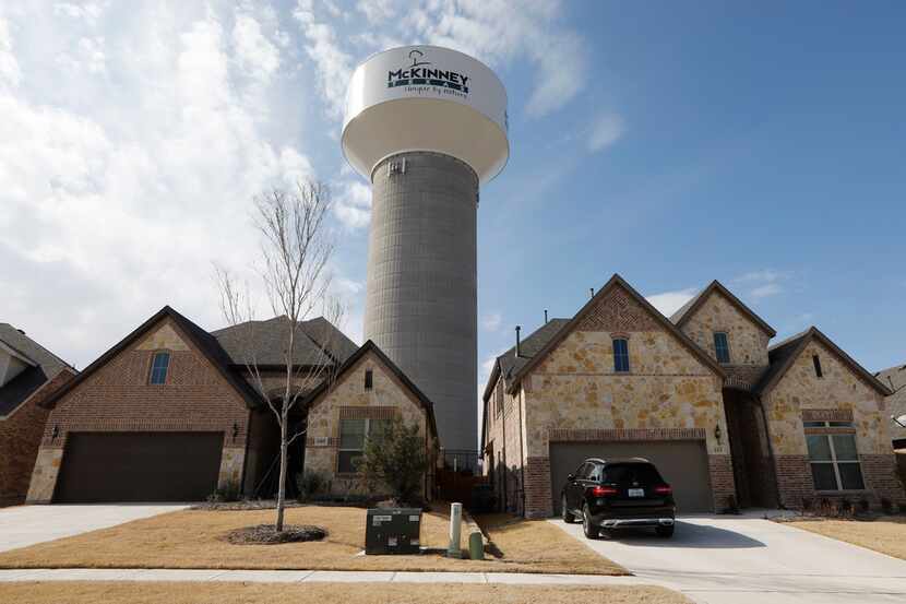 A McKinney water tower looms behind new homes on Leadville Way.