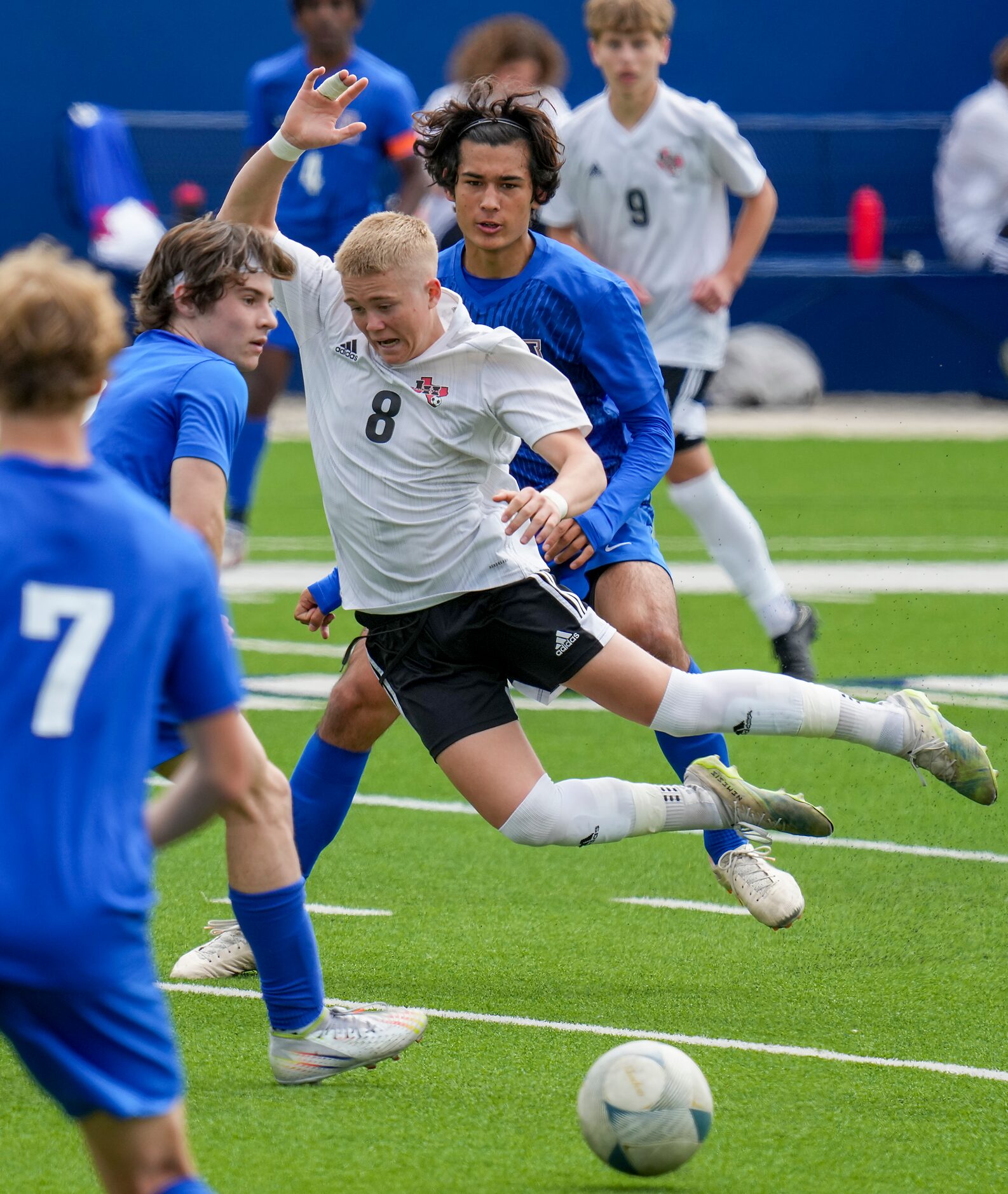 Lake Highlands forward Evan Bernhard (8) is knocked off his feet as he tries to split Allen...