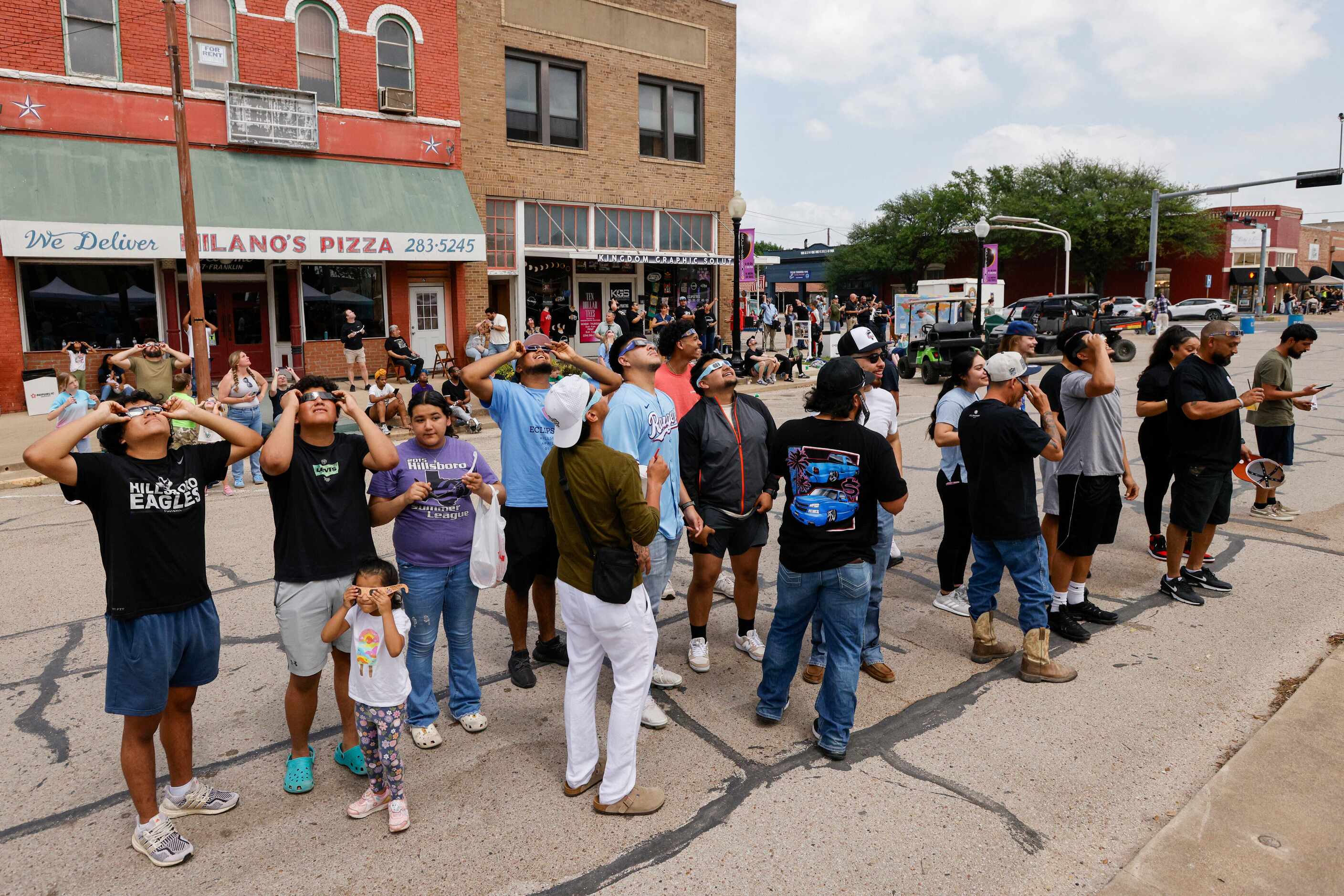 People stand in the square moments before a total solar eclipse, Monday, April 8, 2024, in...