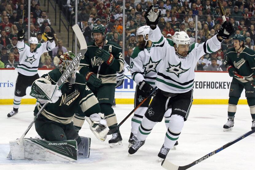 Dallas Stars left wing Patrick Sharp, right, and teammates celebrate after a goal by Stars...