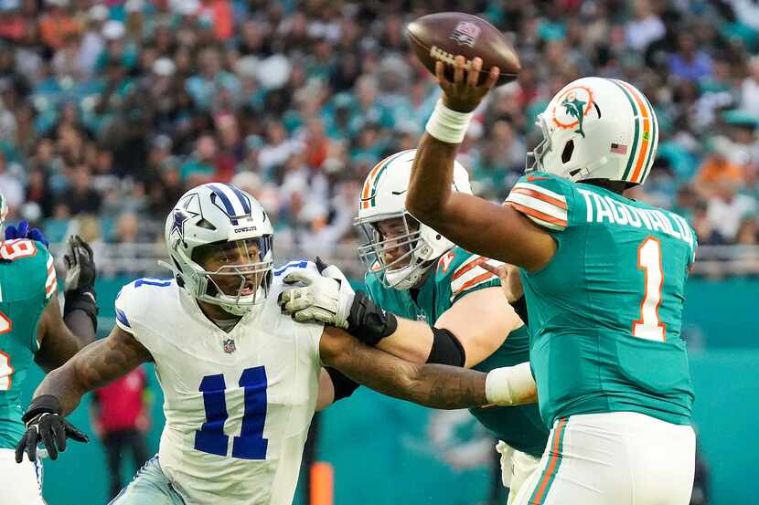 Miami Dolphins quarterback Tua Tagovailoa (1) throws a pass under pressure from Dallas...