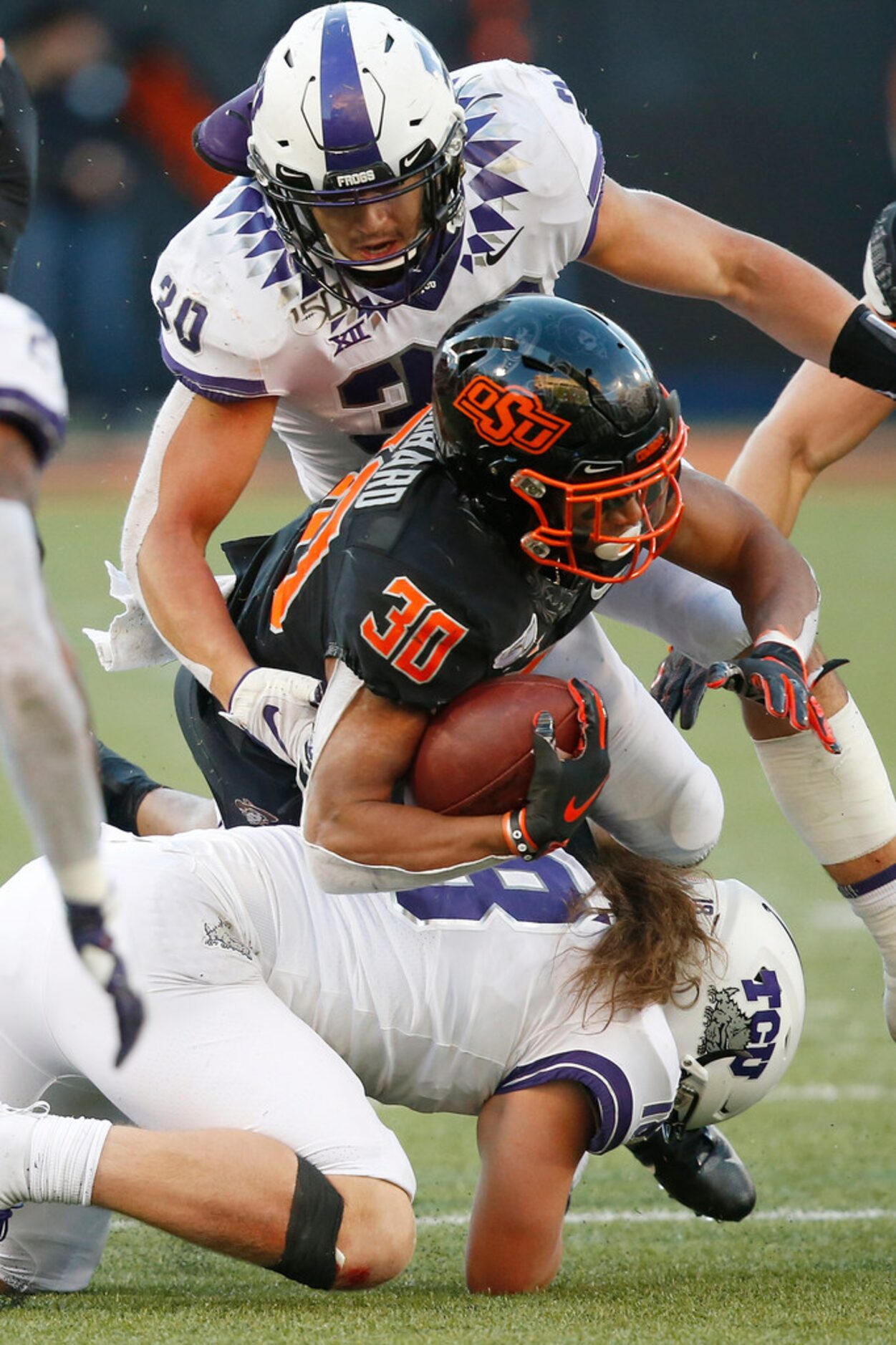 Oklahoma State running back Chuba Hubbard (30) is tackled by TCU linebacker Garret Wallow...