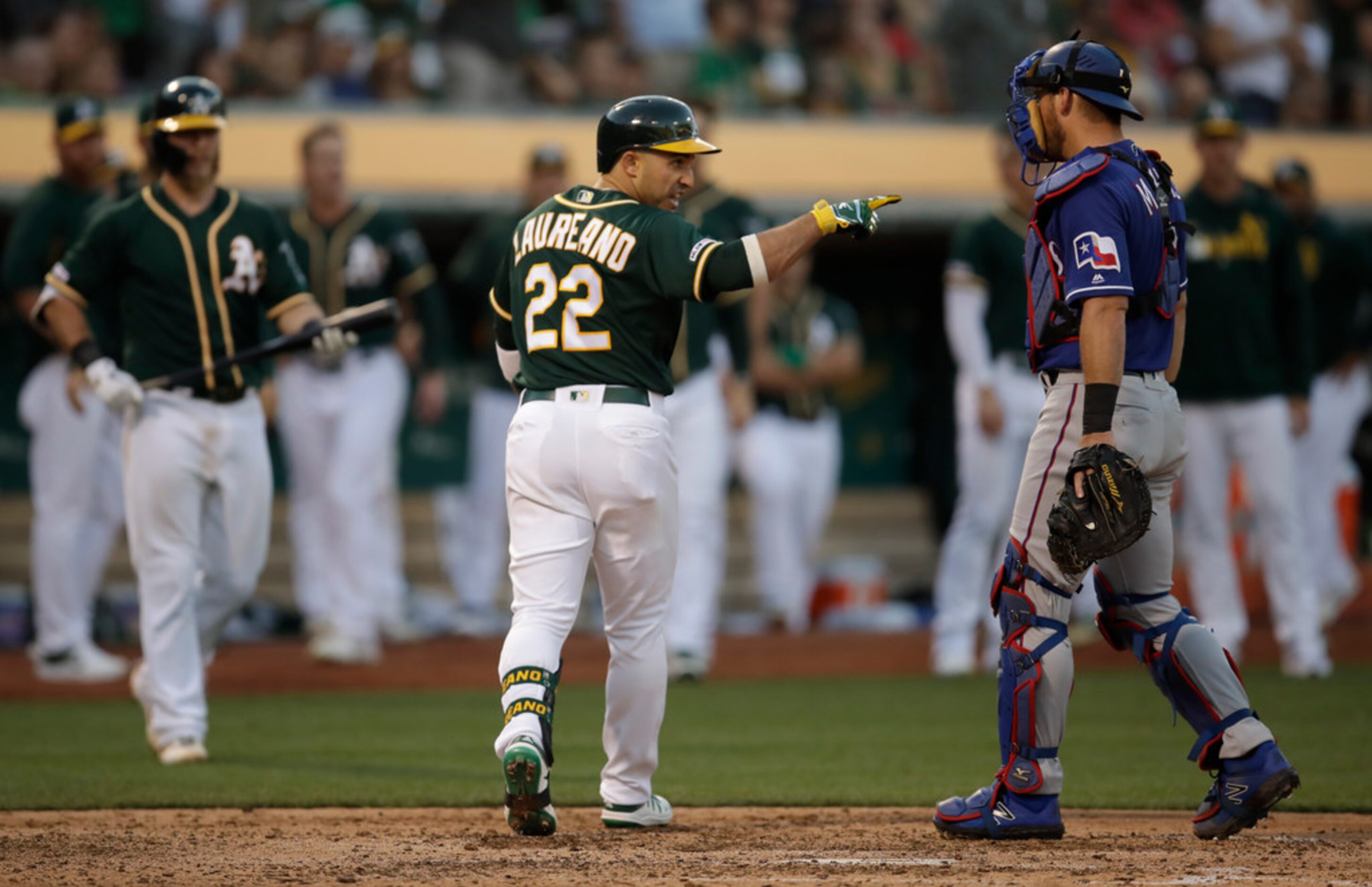 Oakland Athletics' Ramon Laureano (22) gestures after hitting a home run off Texas Rangers'...