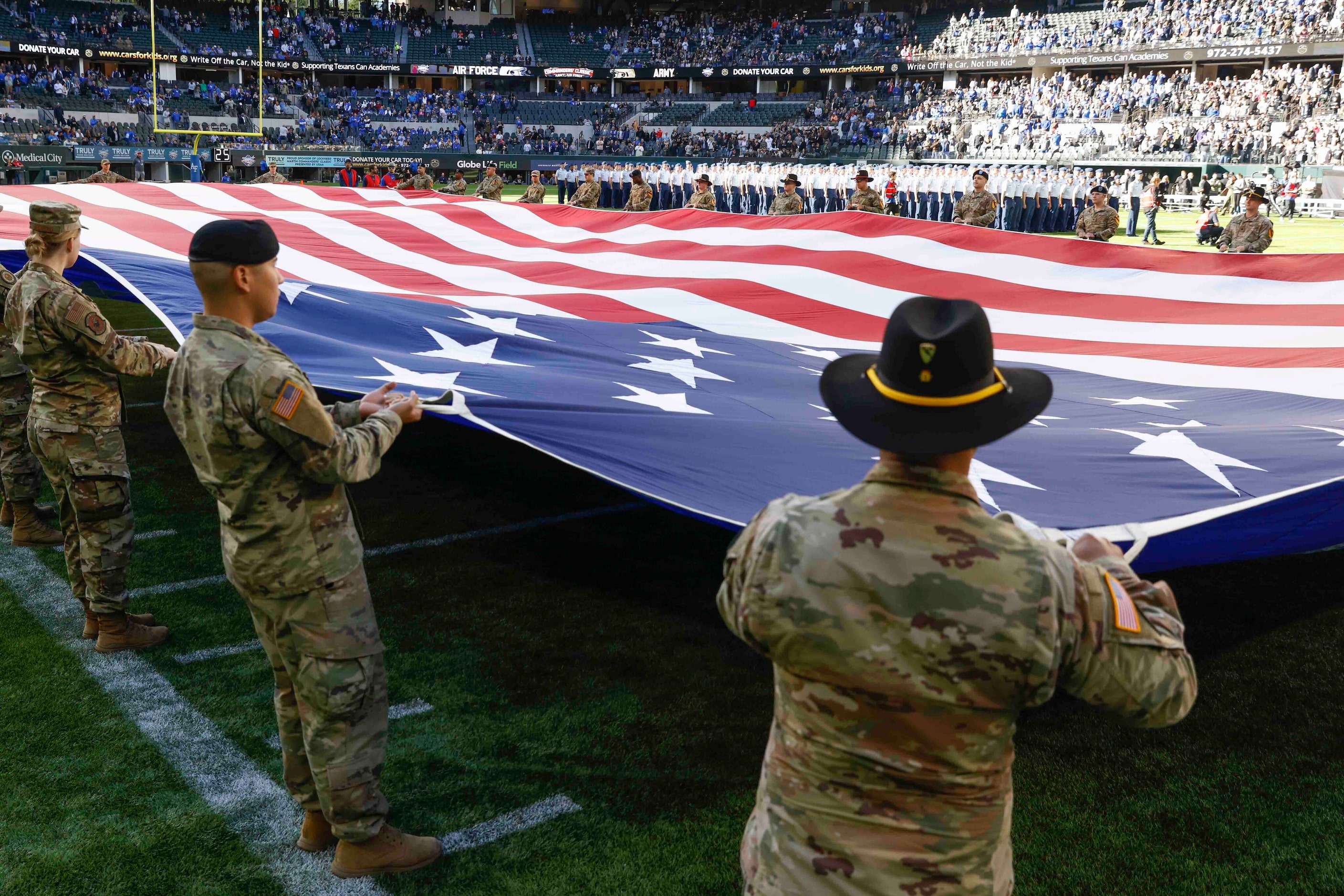 Army cadets display the National flag ahead of an NCAA football game against Air Force at...