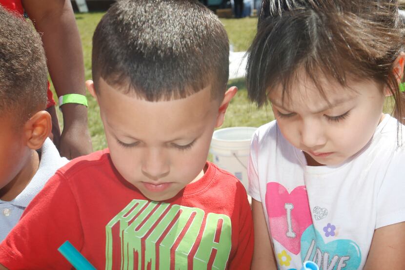 Stevens Park Elementary School pre-K student Israel Flores, 5, lets his sister, Natalie, 4,...