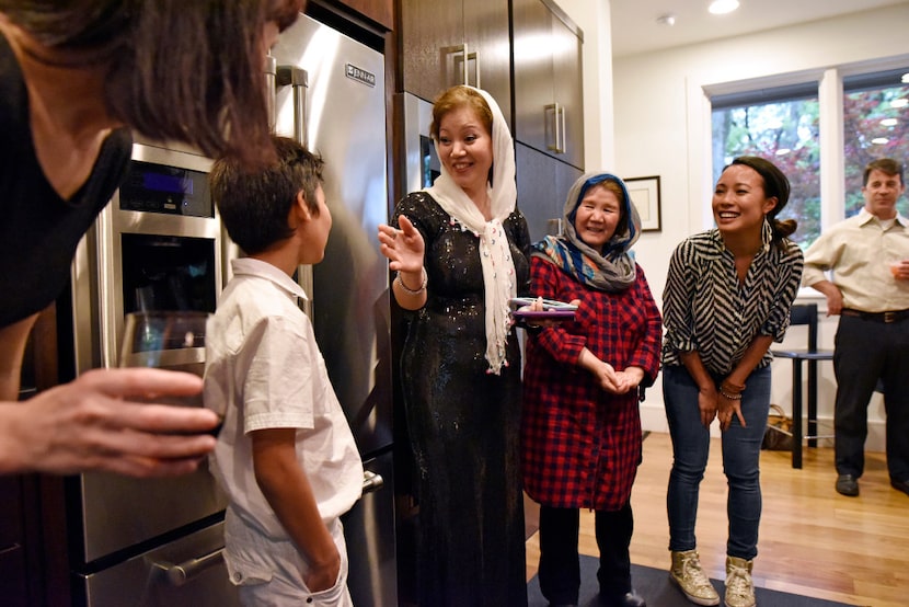 Jamileh Jafari jokes with her son Michael Jafari, left, after she cooked an Afghan style...