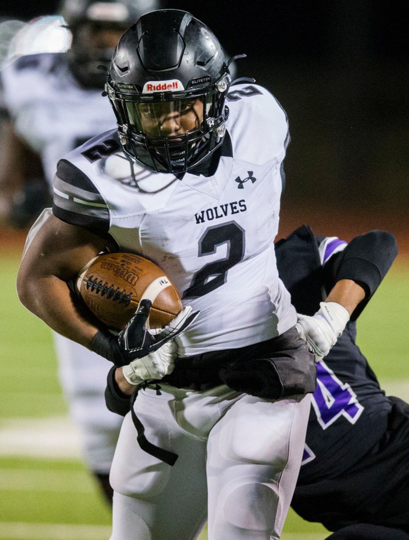 Mansfield Timberview running back Deuce Jones (2) avoids a tackle while running the ball...