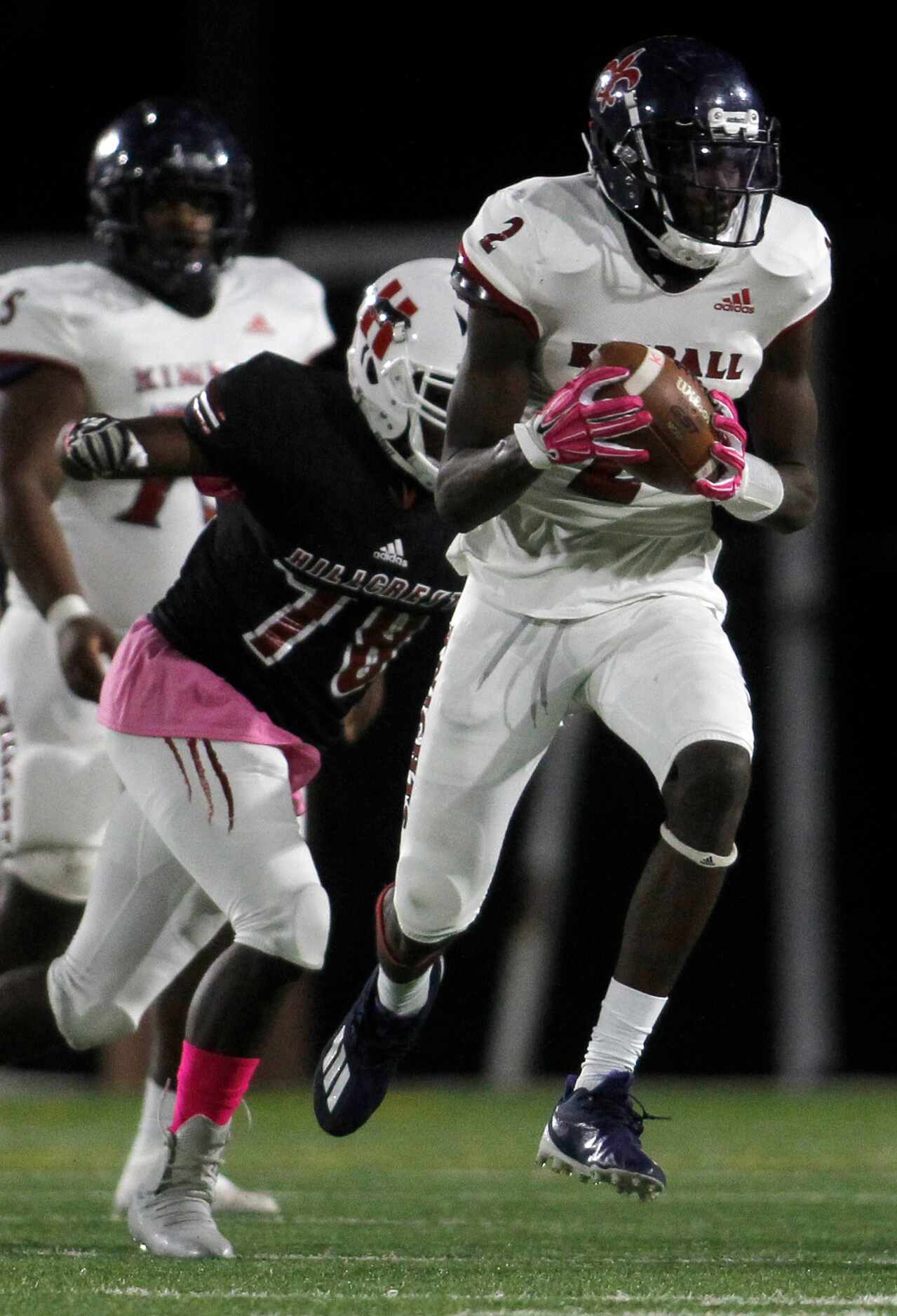 Dallas Kimball receiver Kyron Henderson (2) pulls in a reception as he is defended by Dallas...